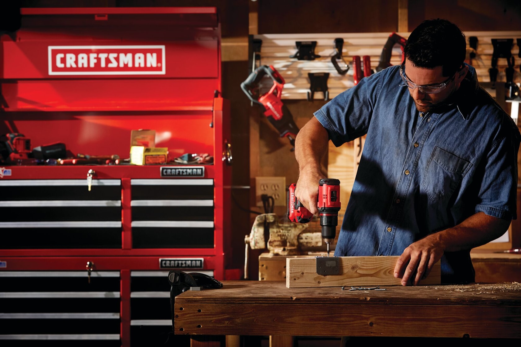 Cordless brushless half inch drill and driver kit 1 battery being used for fixing hinge on wood block.