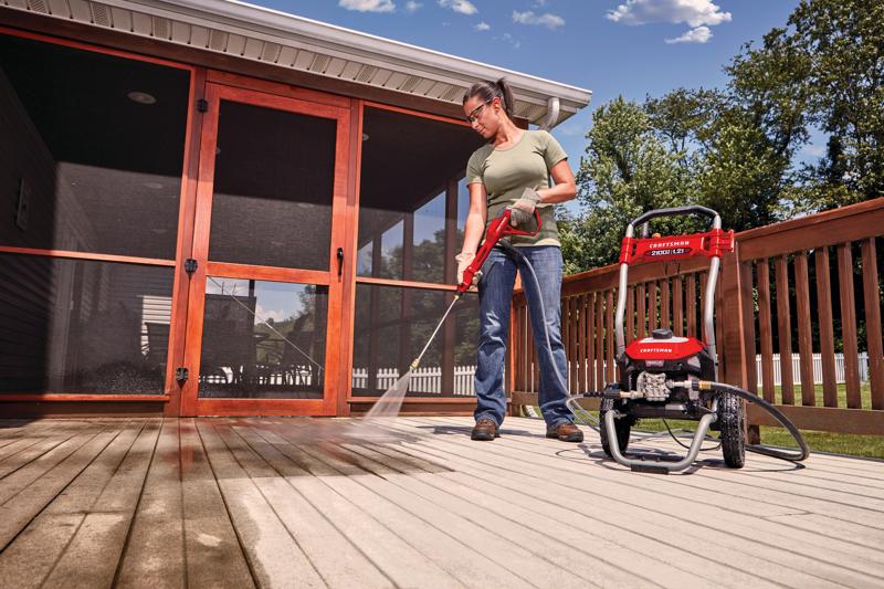 2100 pound per square inch electric cold water pressure washer being used by a person.