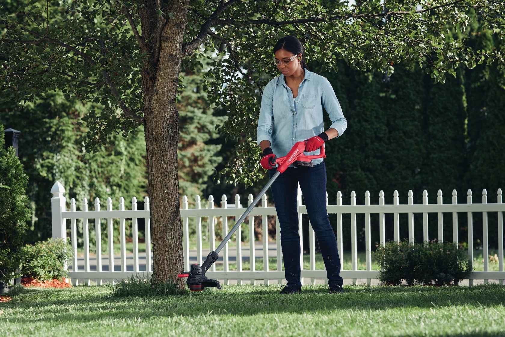 20 volt cordless 10 inch weedwacker string trimmer and edger being used by a person outdoors.