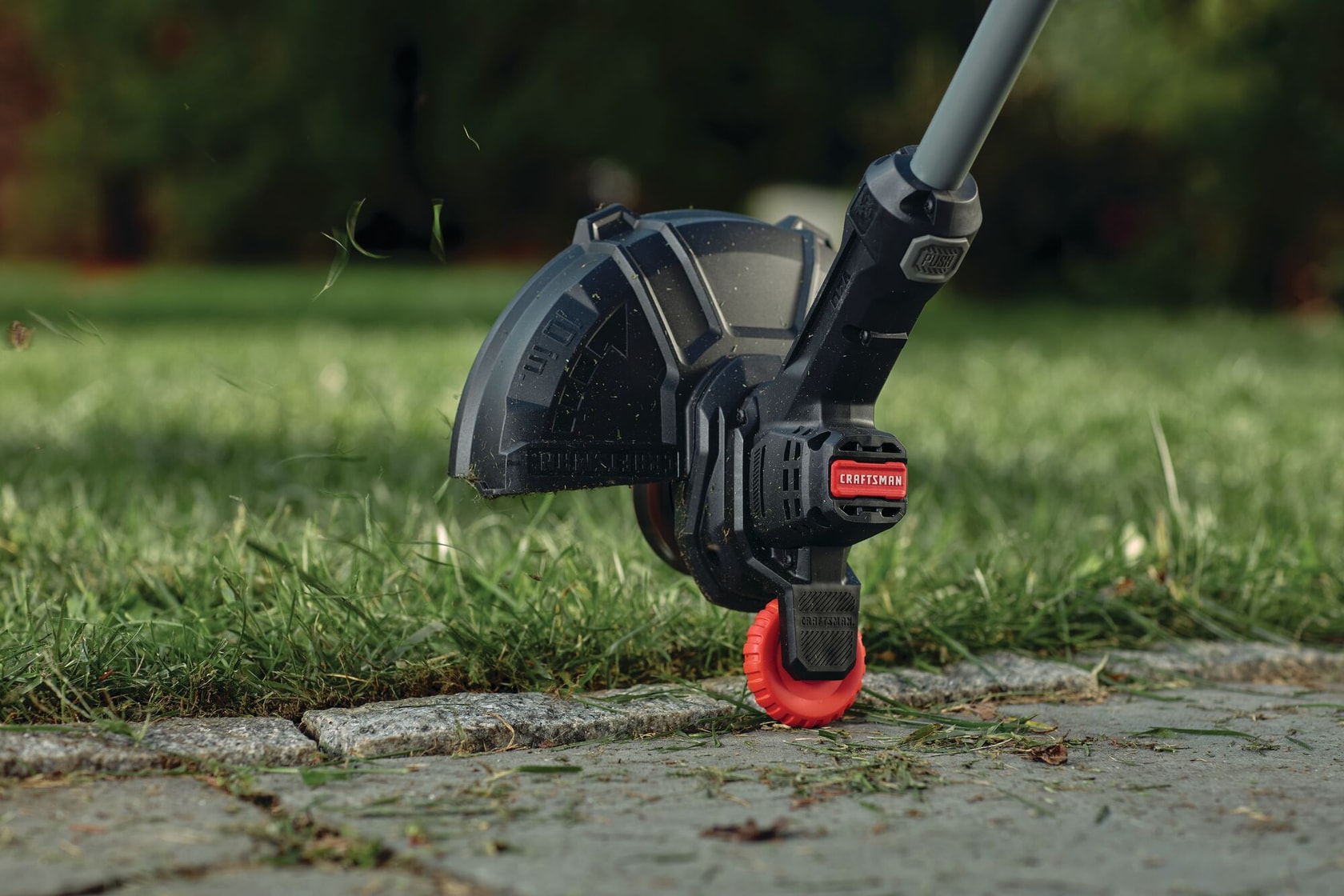 Integrated wheel edged guide feature of 20 volt cordless 10 inch weedwacker string trimmer and edger.