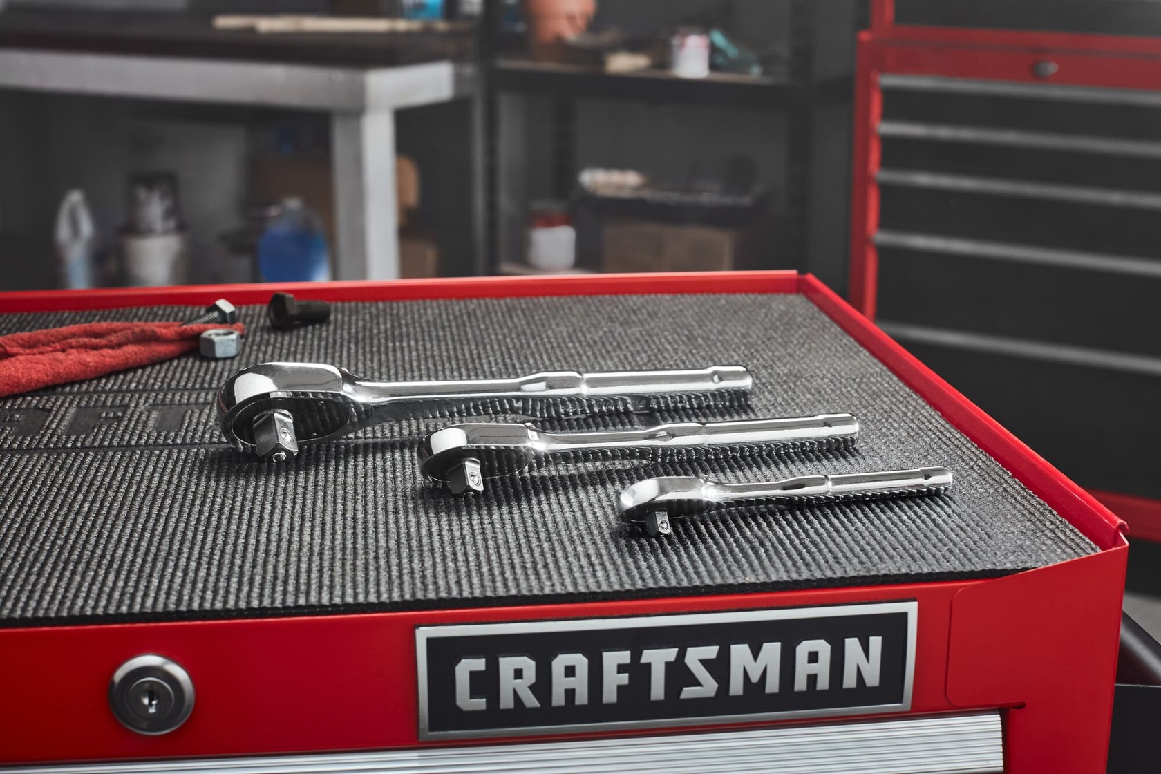 Group shot of 3 CRAFTSMAN Low Profile ratchets on a metal workstation