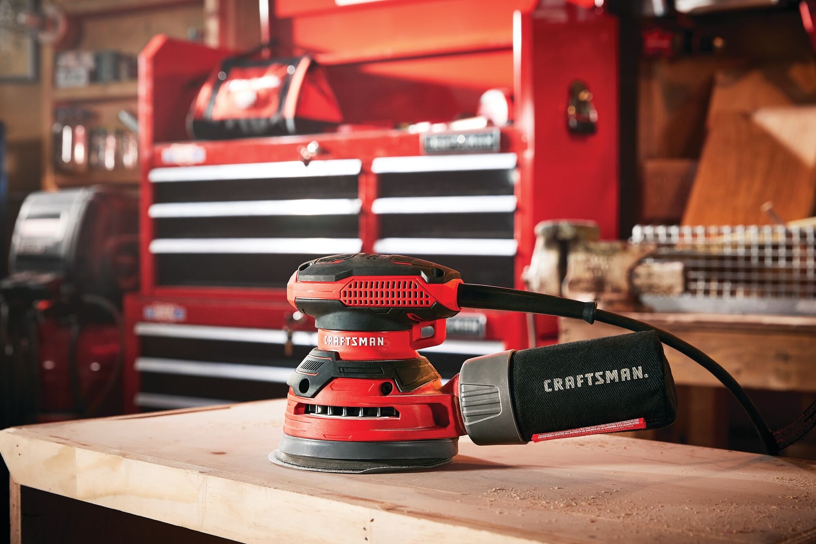3 amp 5 inch random orbit sander placed top of a table in a room.