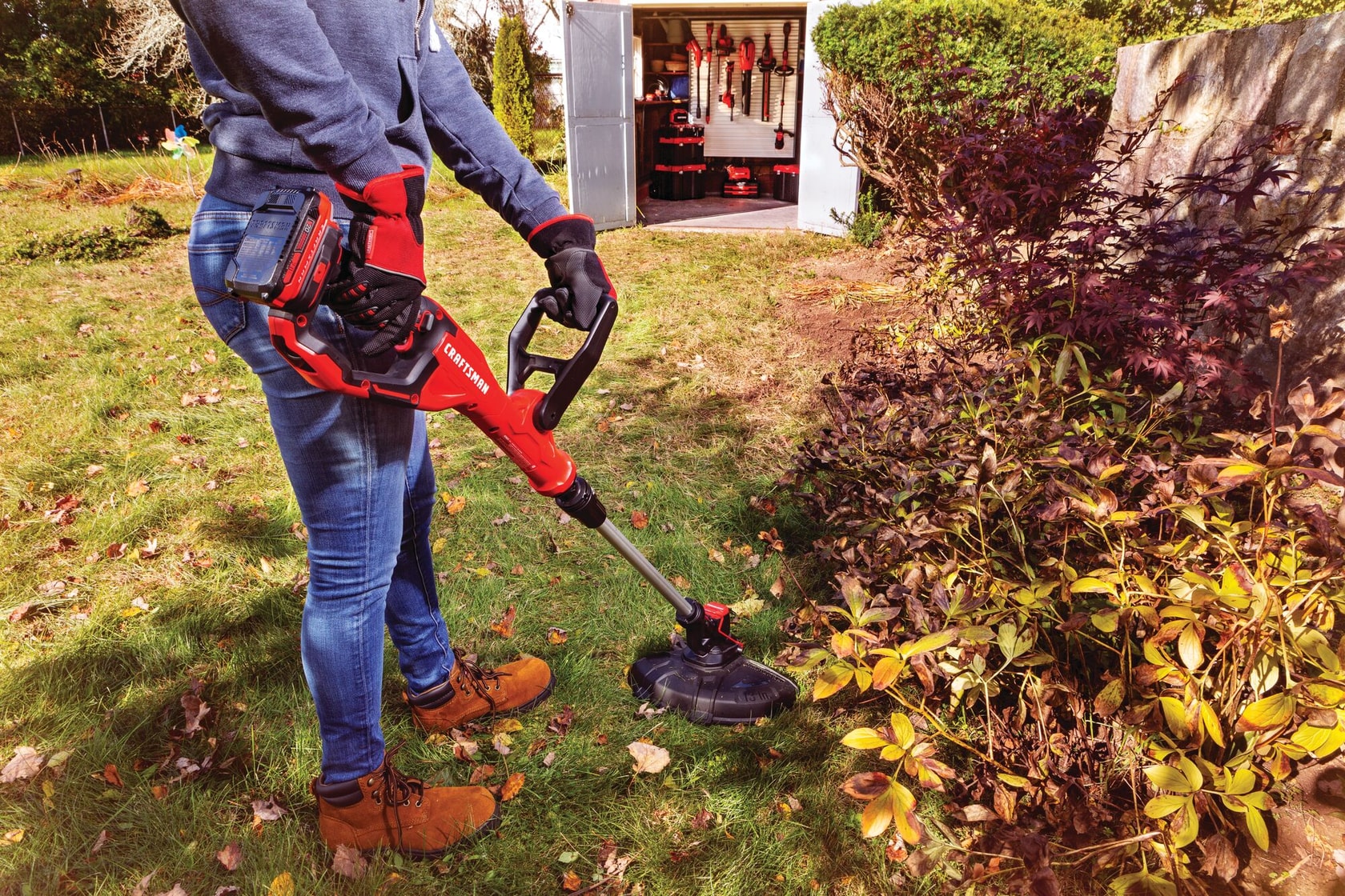 20 volt weedwacker 13 inch cordless string trimmer and edger with automatic feed kit being used by a person in garden.