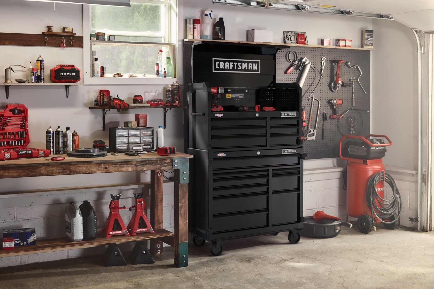 Black CRAFTSMAN Premium S2000 Series 41-inch wide Metal Tool Storage Cabinet and chest stacked on top of each other in a residential garage setting, surrounded by other CRAFTSMAN tools.