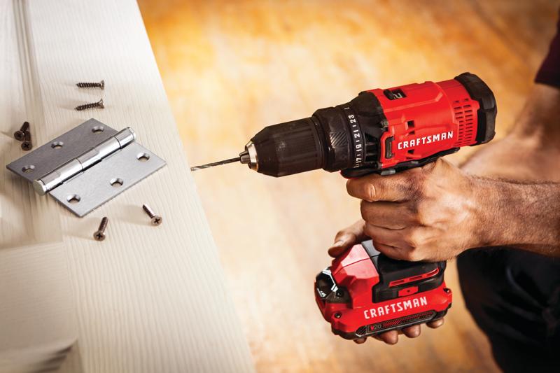 Cordless half inch drill and driver kit 1 battery being used for drilling in wooden door.