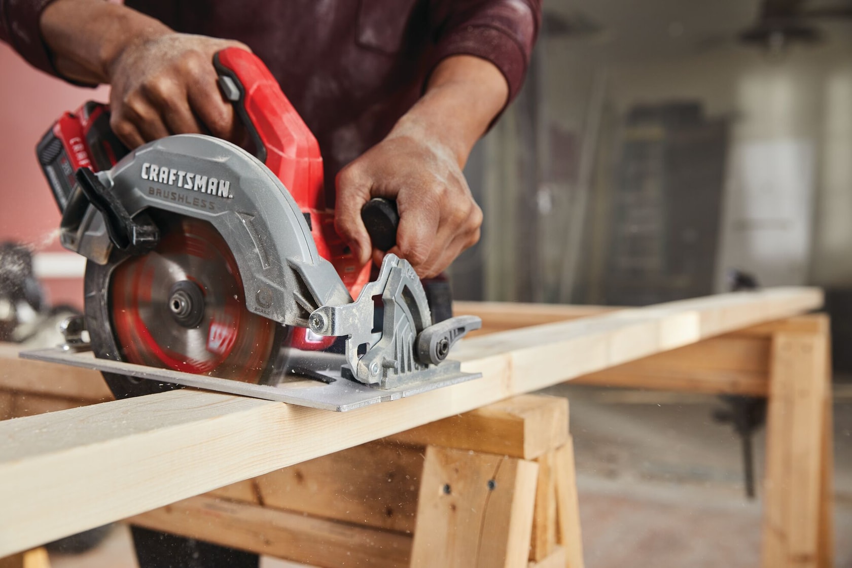 20 volt 7 1 quarter inch brushless cordless circular saw being used by a person to cut wooden plank.