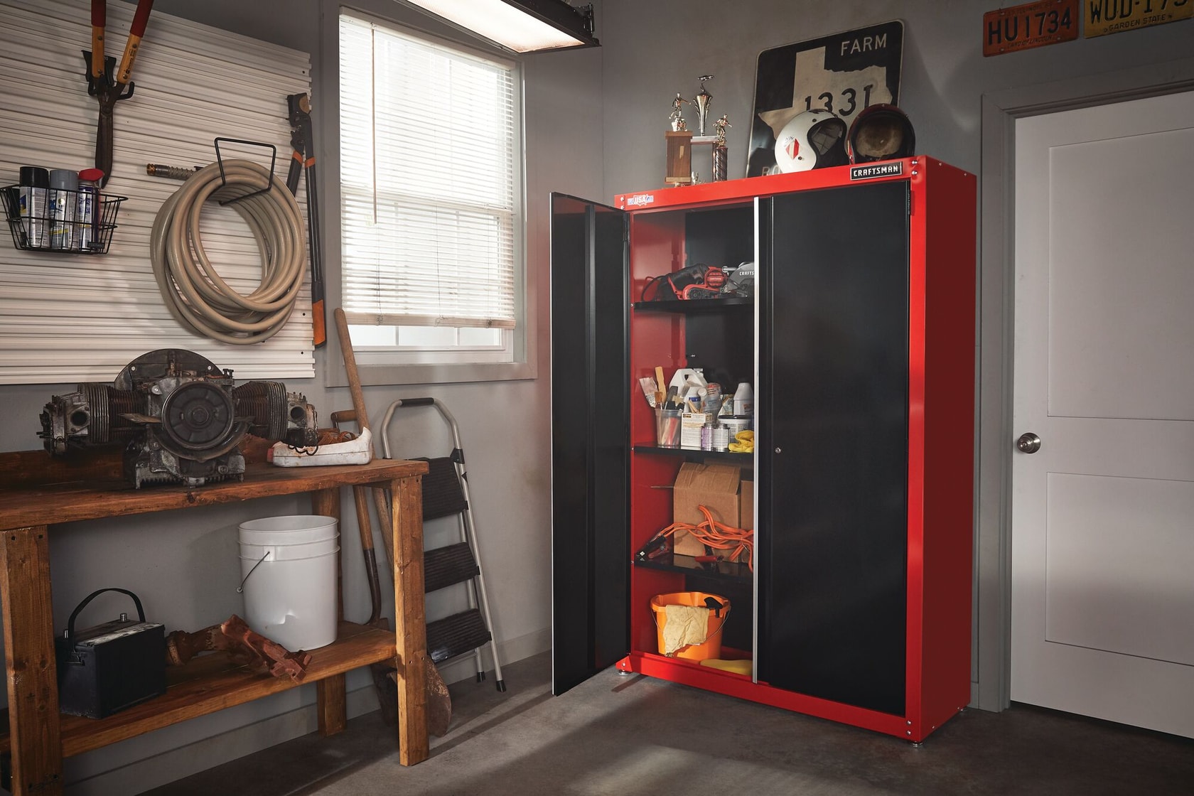 2000 SERIES 48 inch Wide Free Standing Tall Garage Storage Cabinet containing tools and other stuff with one door open placed in storage room.