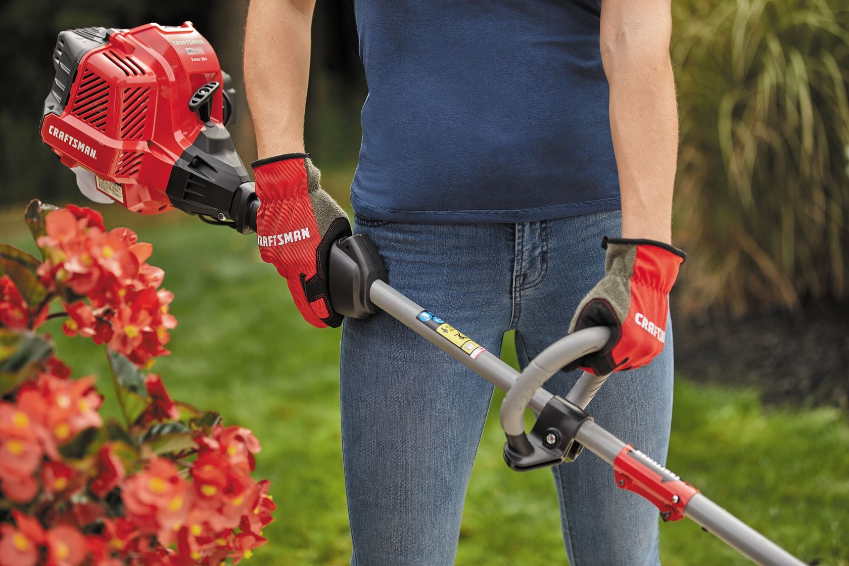 W S 2200 weedwacker 25 C C 2 cycle 17 inch attachment capable straight shaft gas trimmer being carried by a person.