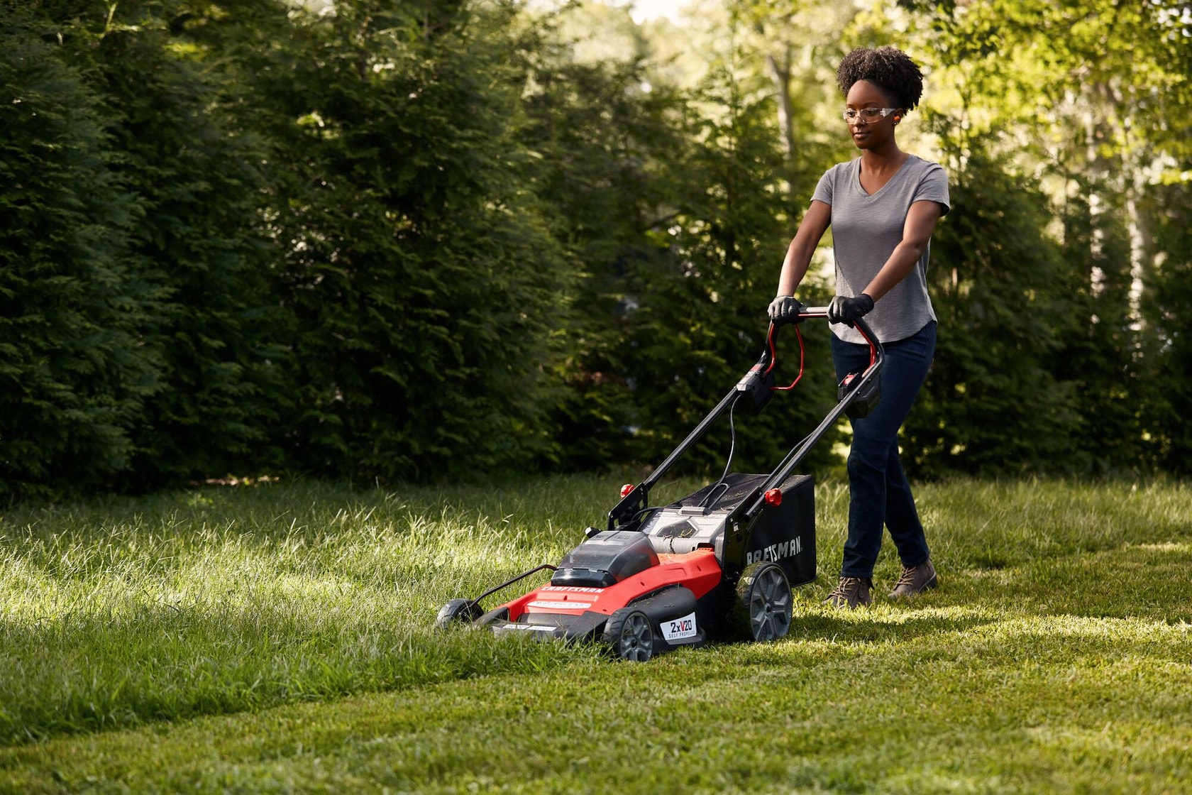 20 inch brushless cordless self propelled mower kit being used for mowing grass.