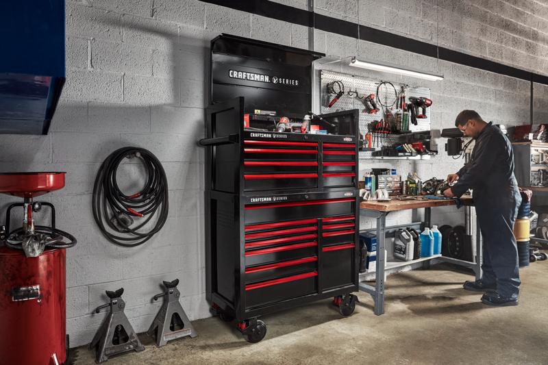 Mechanic working in automotive shop filled with various CRAFTSMAN V-Series™ storage and tools
